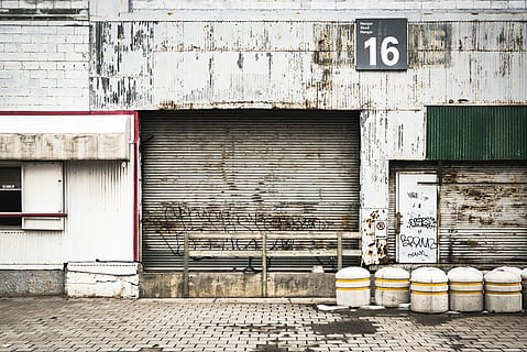 closed gray roll-up doors below 16 signage, white steel garage door HD wallpaper