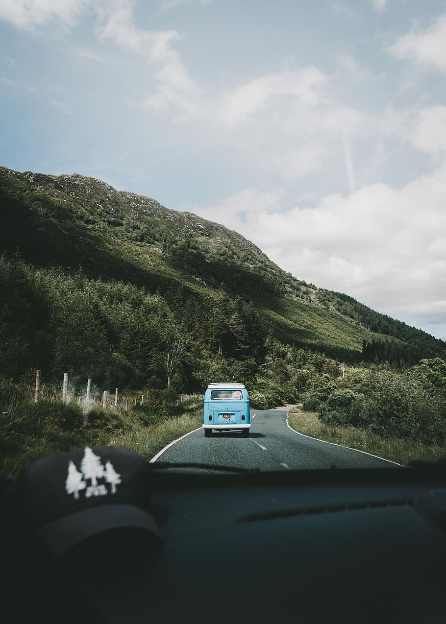 Driving through the Glen, blue camper van near body mountain