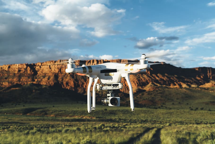 landscape photography of DJI Phantom flying midair in front of mountain, white DJI phantom drone HD wallpaper