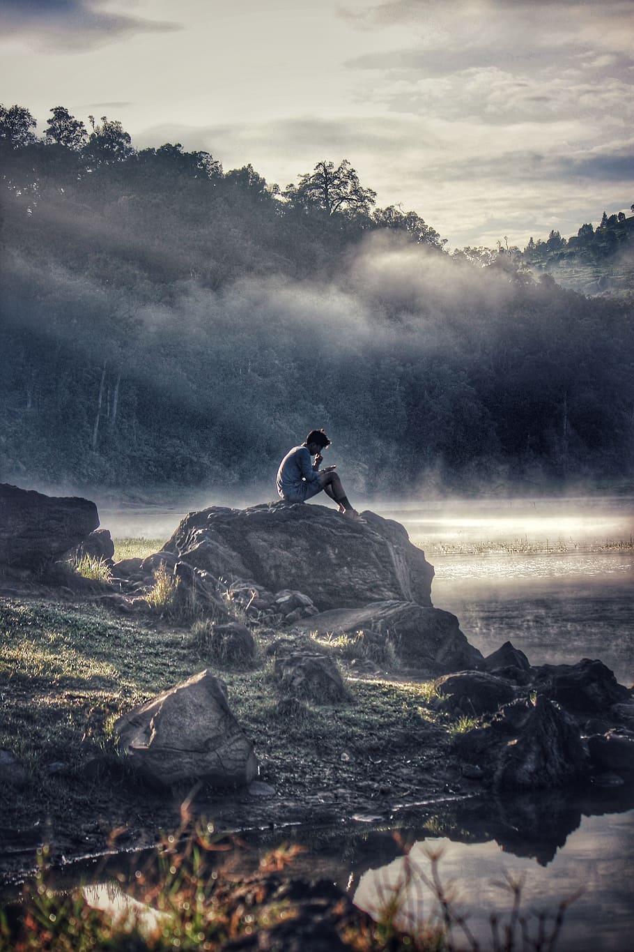 Man in Gray Shit Sitting on Rock Boulder, adventure, alone, clouds