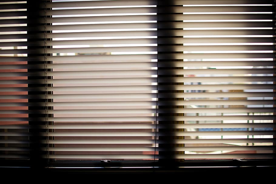 low-light photo of venetian blinds, window blinds, office, office window
