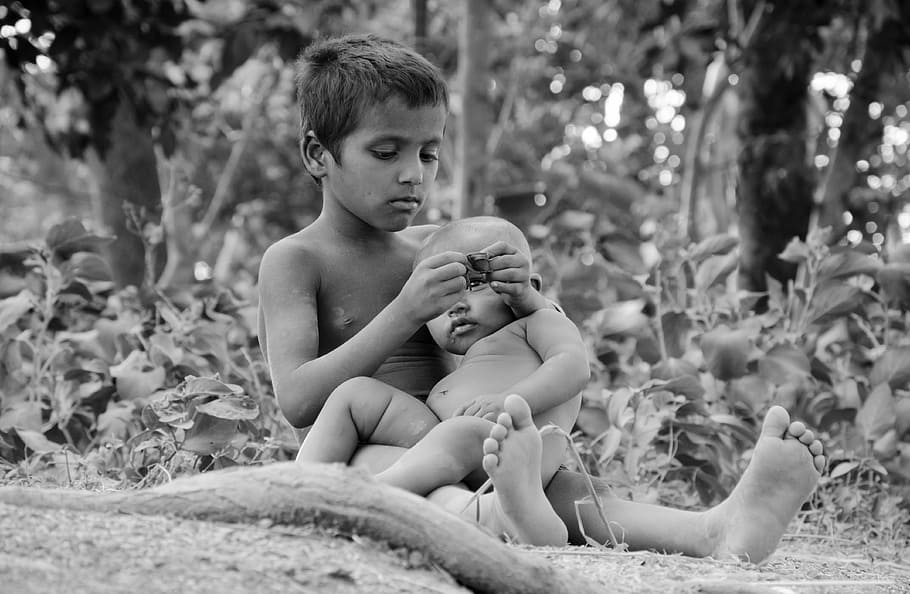 grayscale photography of boy carrying toddler, poor, baby, child