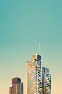 gray concrete building at daytime, high-rise building under clear green sky HD wallpaper