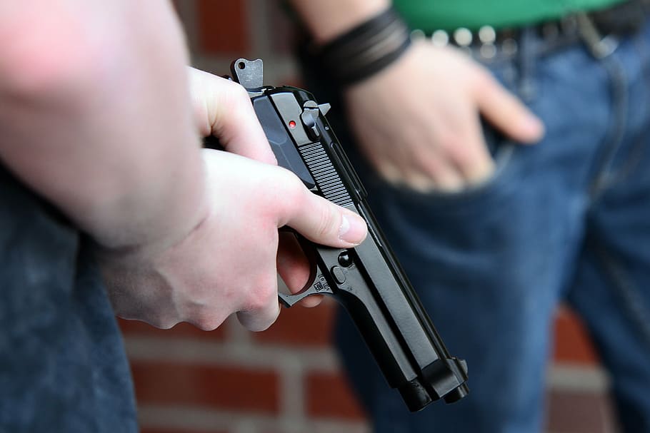 person holding black semi-automatic pistol, youth, weapon, beretta