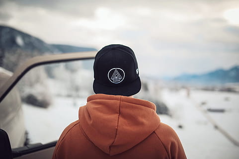 Person Wearing Black Cap and Orange Hoodie Turning His Back, automobile HD wallpaper