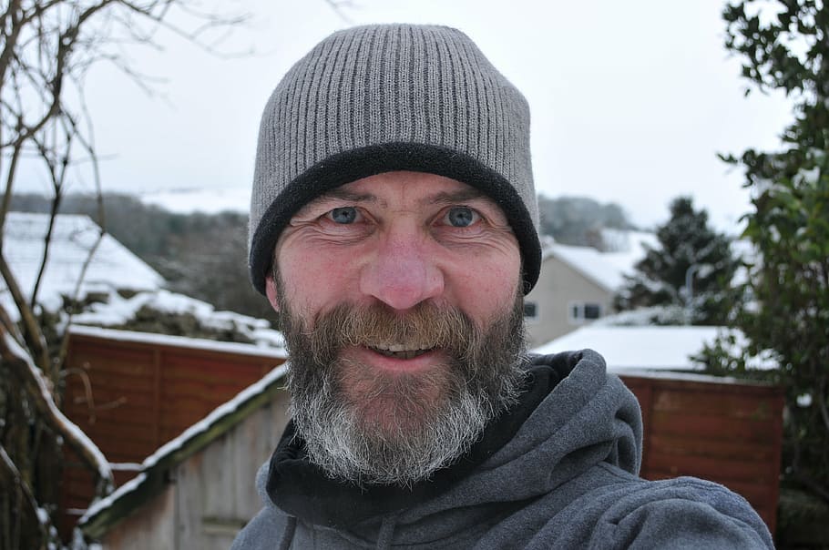 smiling man wearing gray knit hat outdoor, male, beard, woolly hat HD wallpaper