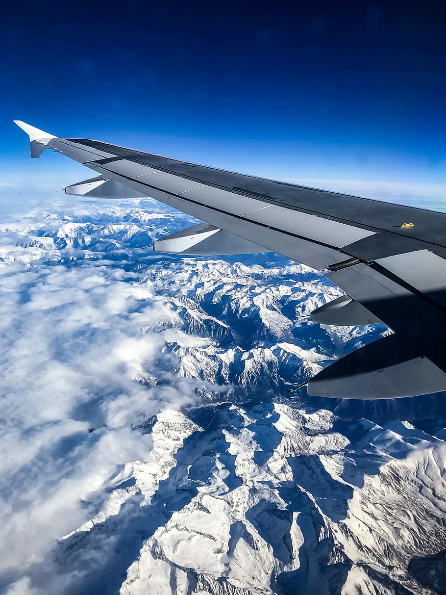 gray right airplane wing, aerial view photography of mountain alps HD wallpaper