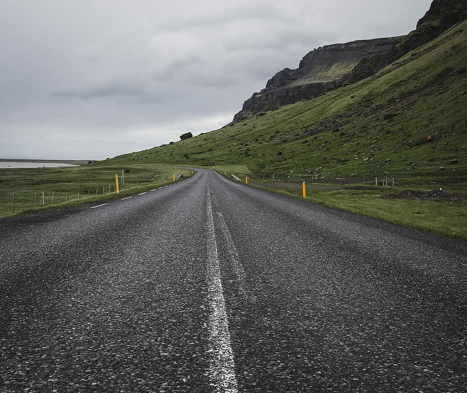 empty concrete road near mountain under cloudy sky at daytime, asphalt road near mountain during daytime HD wallpaper