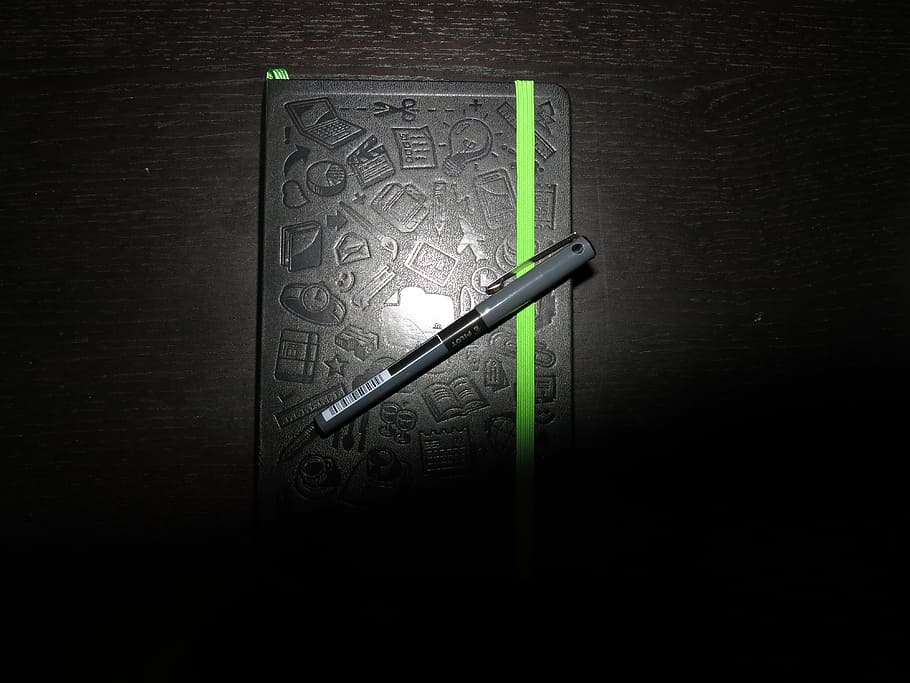 gray and black ballpoint pen on black labeled book, notebook HD wallpaper