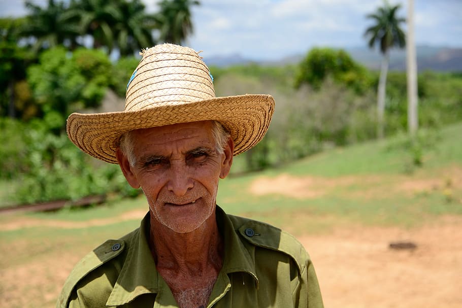 man smiling in shallow focus lens, farmer, hat, facing camera HD wallpaper