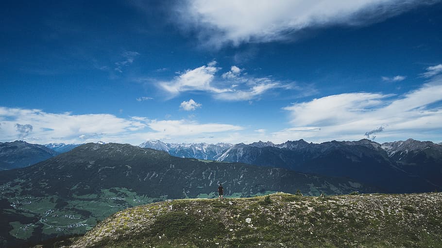 man standing on hill under white and blue cloudy sky, man in black shirt standing on cliff HD wallpaper