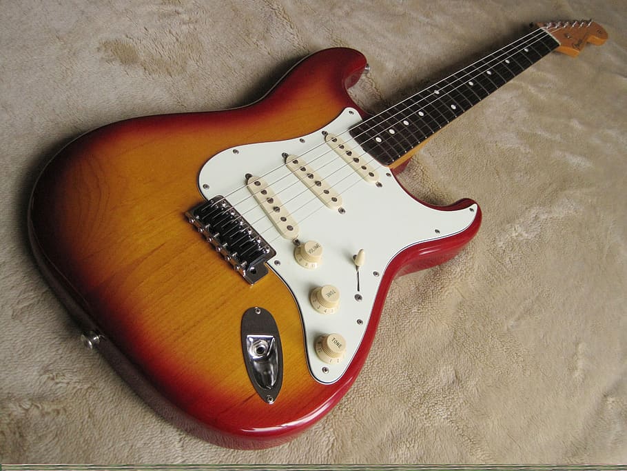 sunburst Stratocaster-style electric guitar, fender, musician