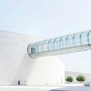child playing kick scooter beside man outside the building, two people walking next to white concrete structure HD wallpaper