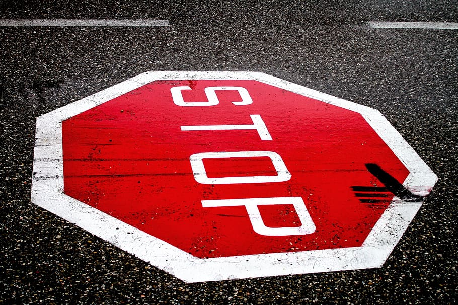 red and white stop signage on gray asphalt surface, road, road sign