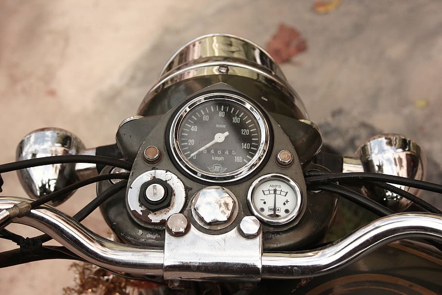 close-up photo of black motorcycle instrument cluster panel, bike