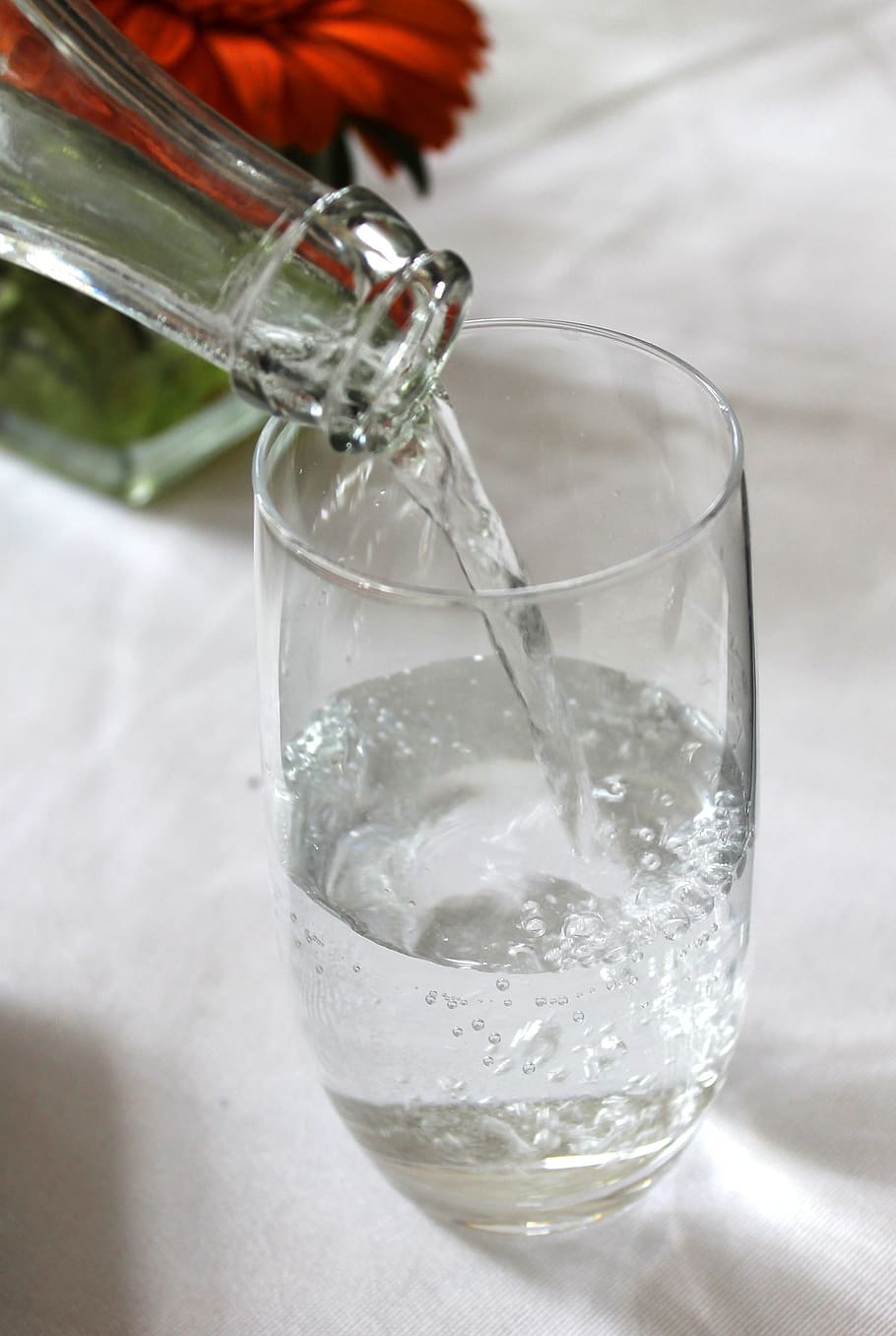 clear glass bottle pouring clear liquid into clear drinking glass HD wallpaper