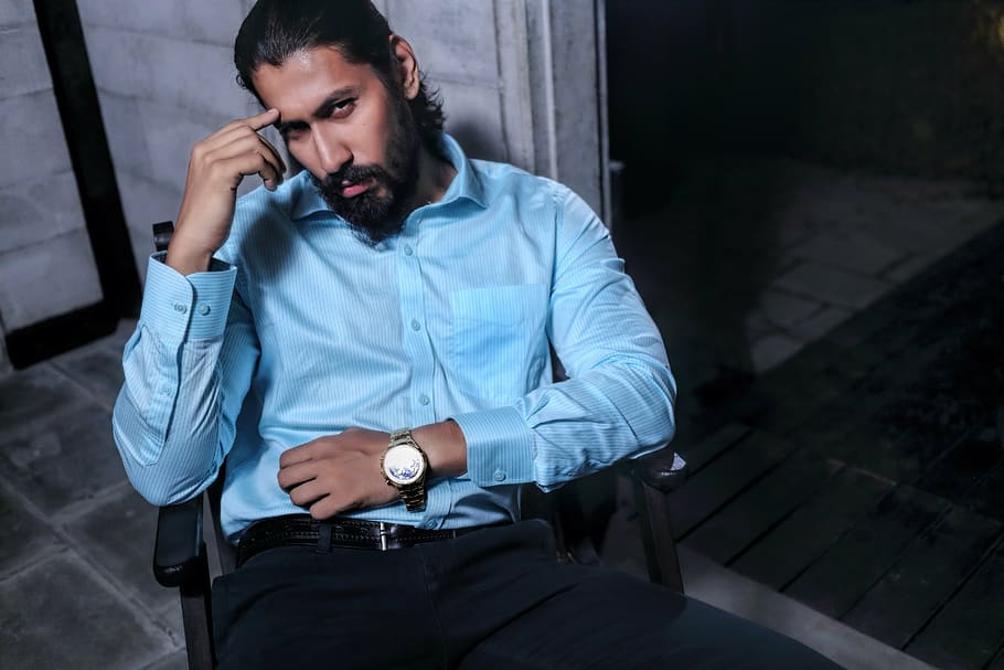 man wearing blue dress shirt sitting on black armchair, model HD wallpaper