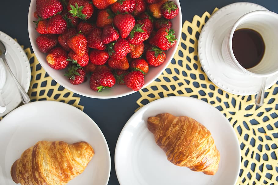 Fresh buttery croissants, hot cup of coffee and bowl with strawberries HD wallpaper