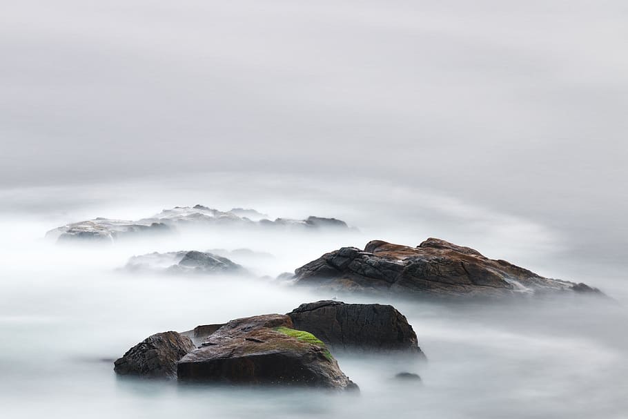 time lapse photography of water near island, boulders with fog photo HD wallpaper