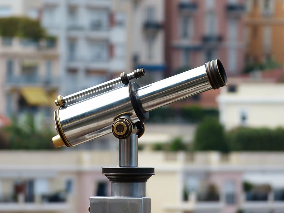 person taking photo of stainless steel coin generated telescope in tilt shift photography HD wallpaper