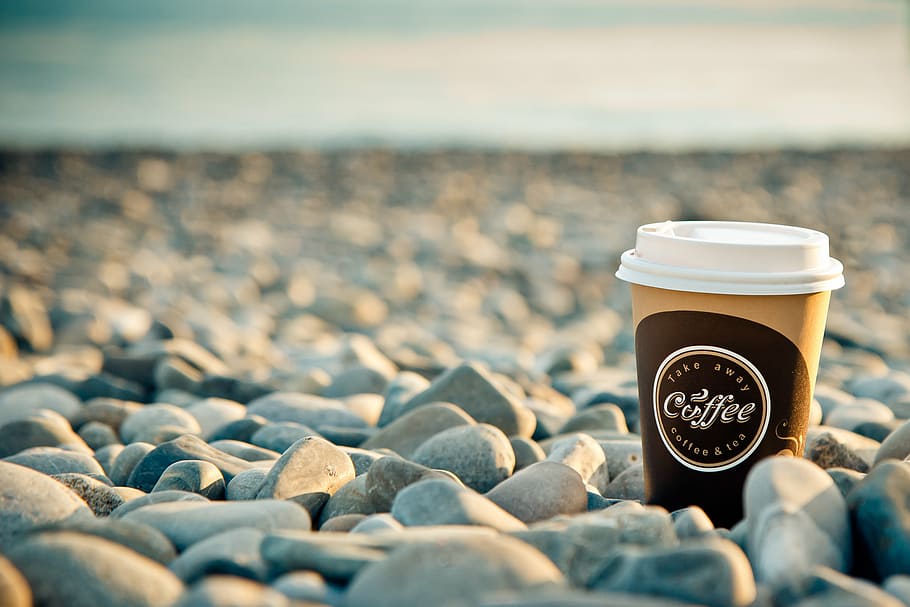 Coffee cup on stones, sea, morning, breakfast, beach, good morning