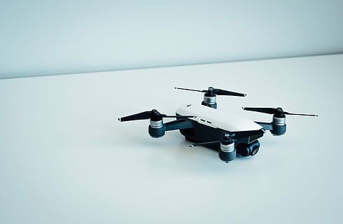 white and black quad copter drone, white and black drone on white floor HD wallpaper