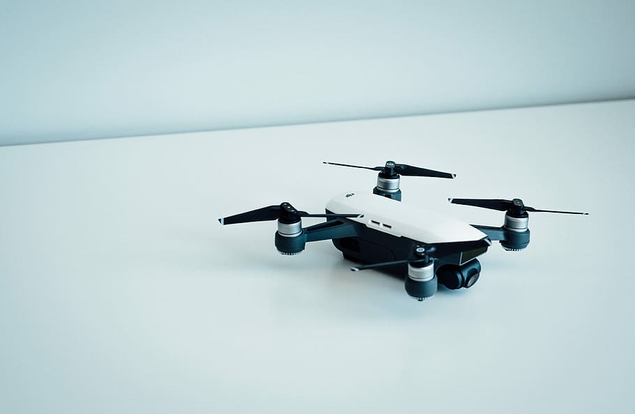 white and black quad copter drone, white and black drone on white floor HD wallpaper