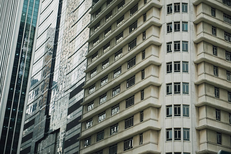 white concrete glass building, brown and white buildings during daytime HD wallpaper
