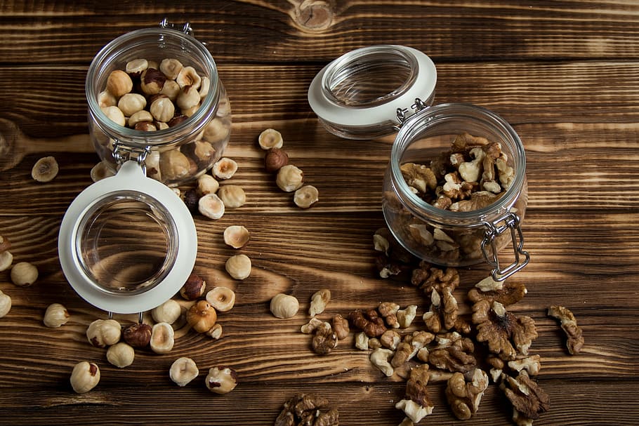 two clear mason jars on brown wooden table, nuts, filbert, walnut HD wallpaper