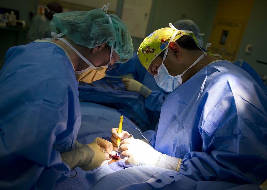 surgeons having medical operation inside operating room, surgery