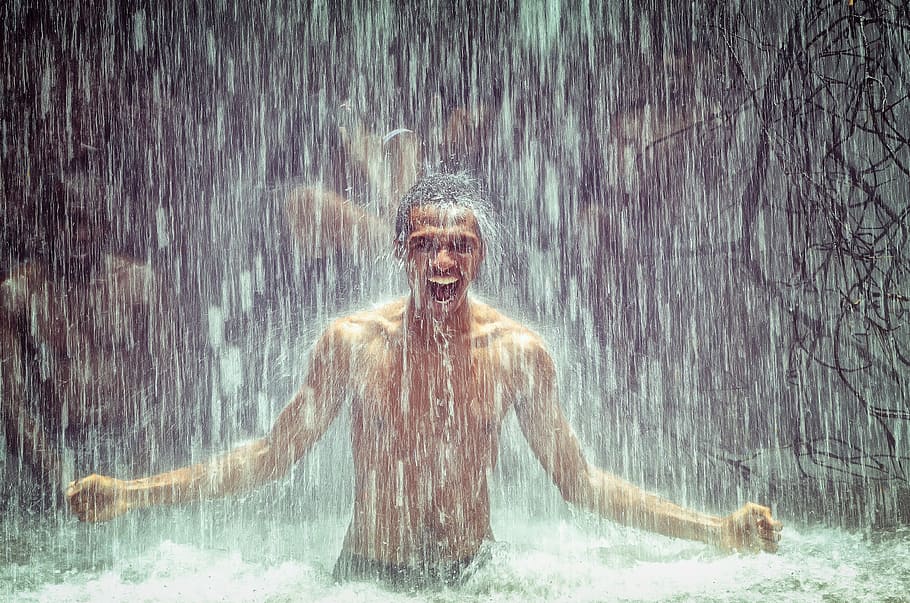 man under body of water during daytime, man under waterfall HD wallpaper