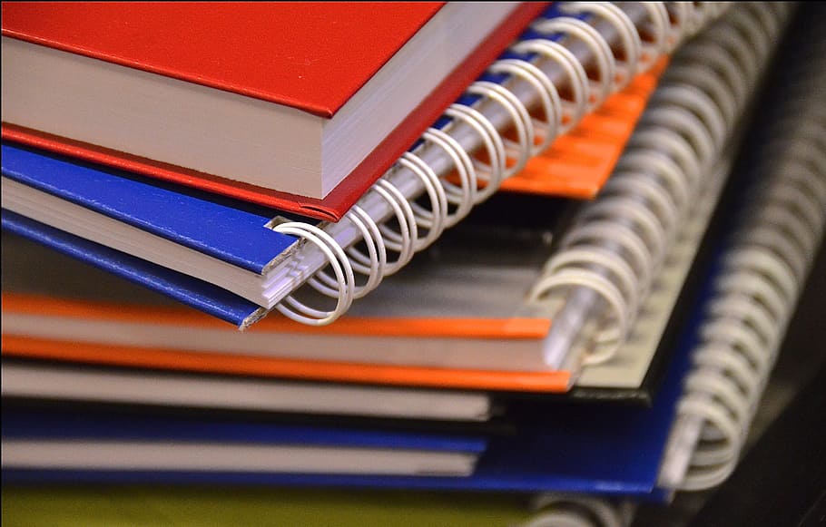 assorted notebooks with spiral springs shallow focus photography HD wallpaper