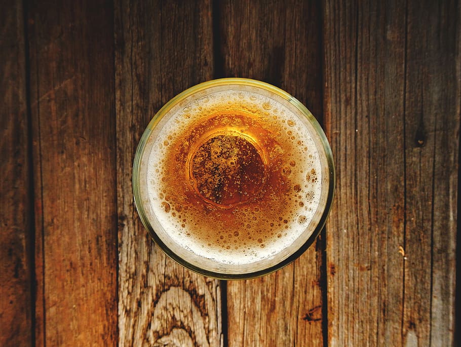 liquid-filled round cup on brown plank, beer, alcohol, drink HD wallpaper