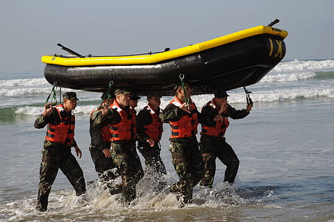 group of men carrying black and yellow inflatable boat, teamwork HD wallpaper