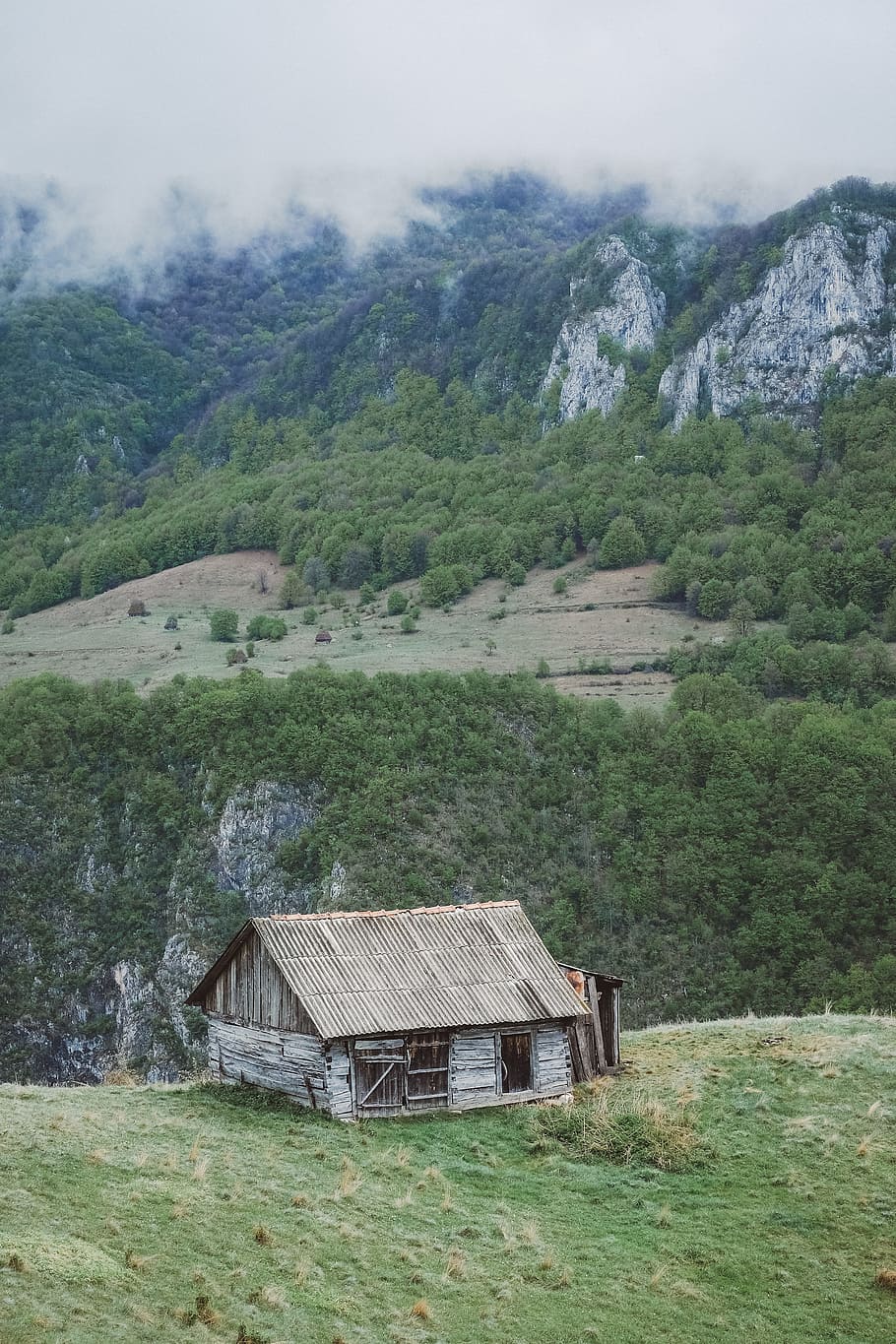 gray wooden house on mountain, brown wooden cabin on mountain