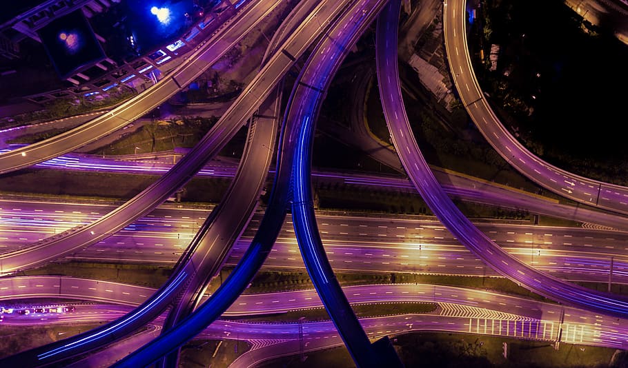 time-lapse photography of vehicles passing on road at night time HD wallpaper