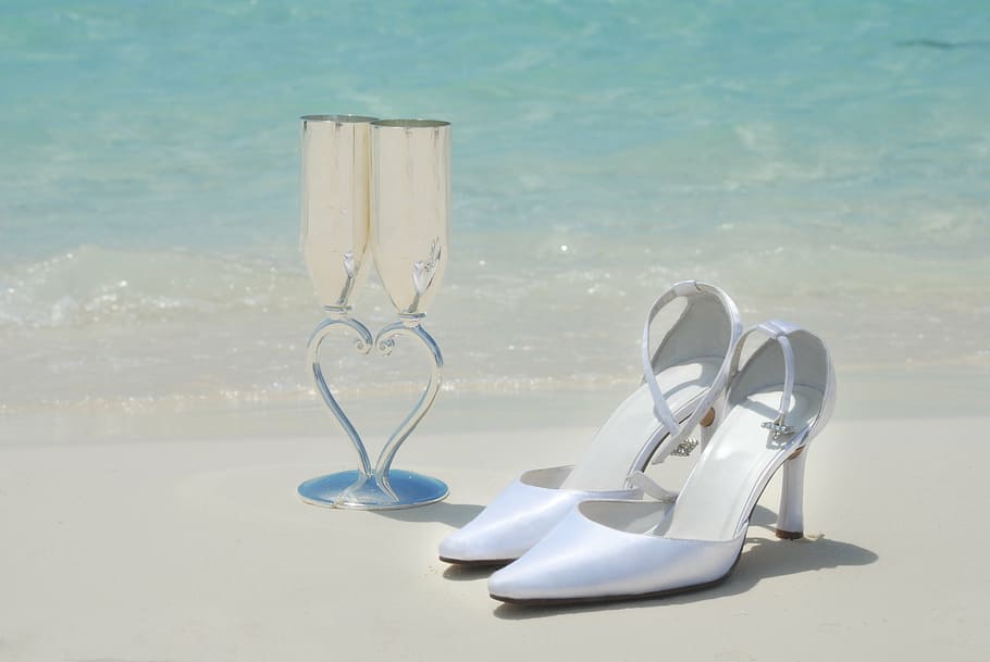 pair of white pointed-toe pumps near wine glasses in seashore, HD wallpaper