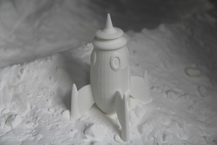 white rocket figurine on white sand, printing, 3d, food, indoors HD wallpaper