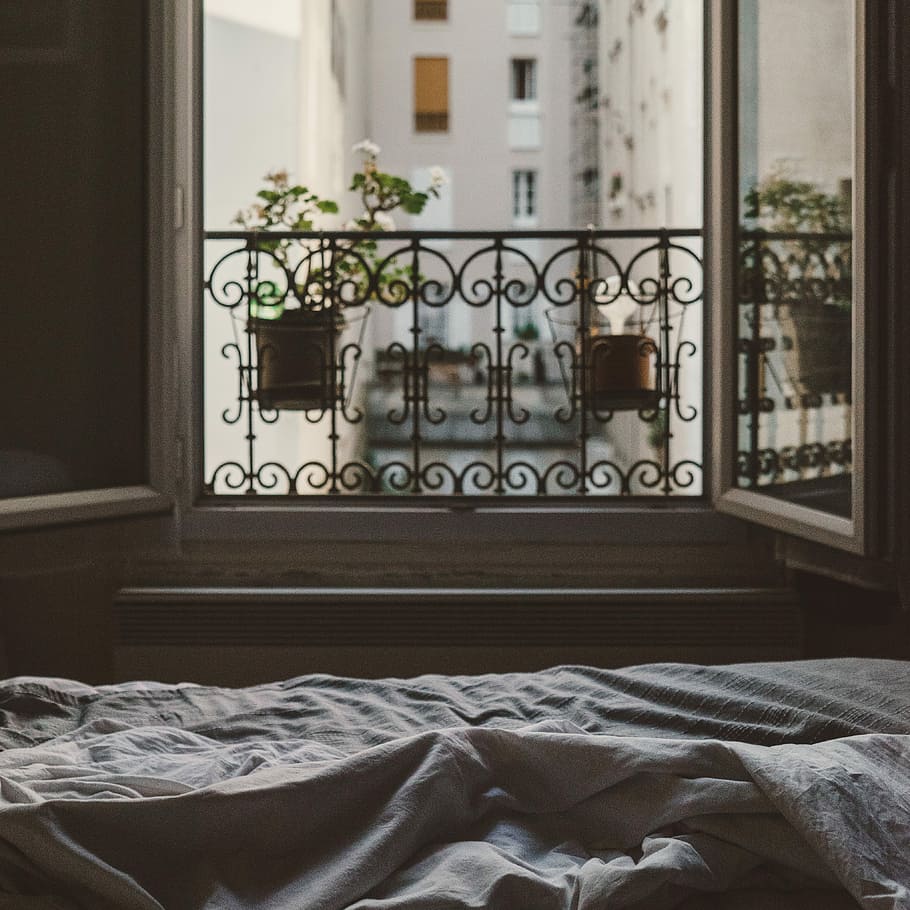 closeup photo of open window with flower, gray bed cover near open window during daytime HD wallpaper