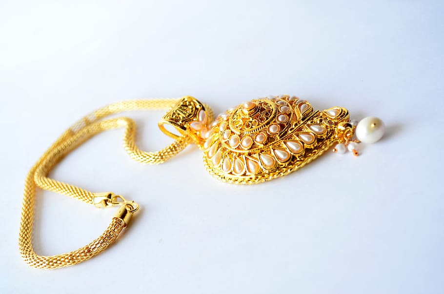 gold-colored necklace on white surface \], jewelry, luxury, fashion