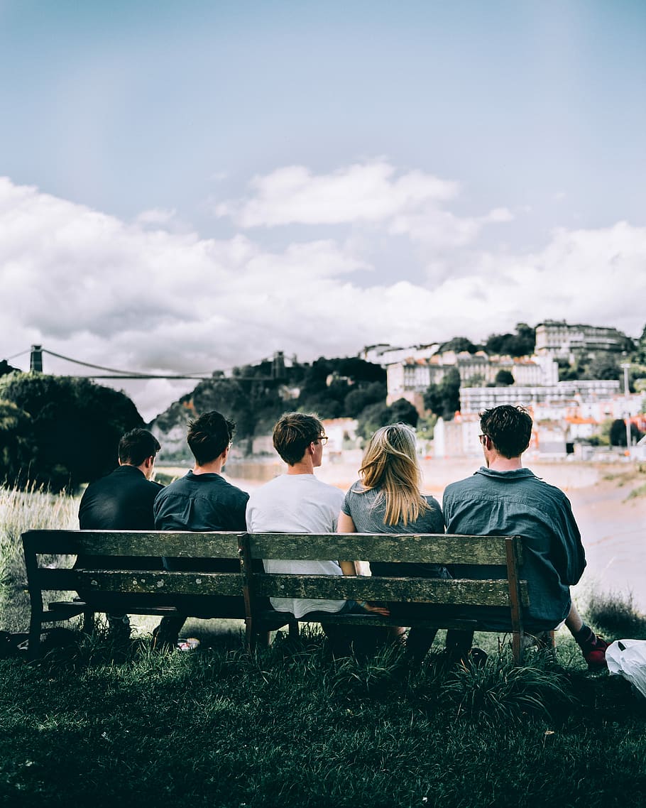 Enjoy the View, five people sitting on gray wooden bench overlooking city HD wallpaper