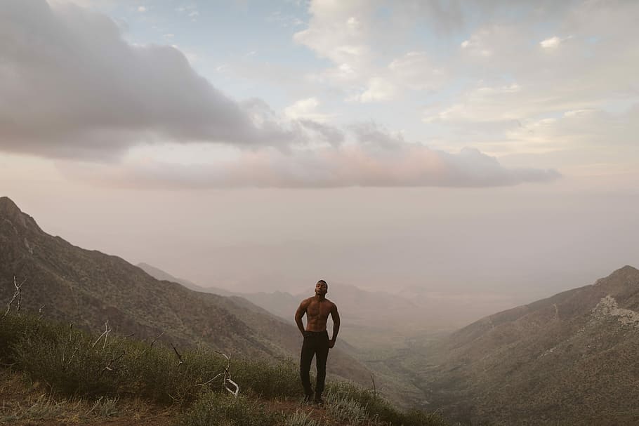 man standing on mountain peak under white clouds, man standing on mountain, HD wallpaper