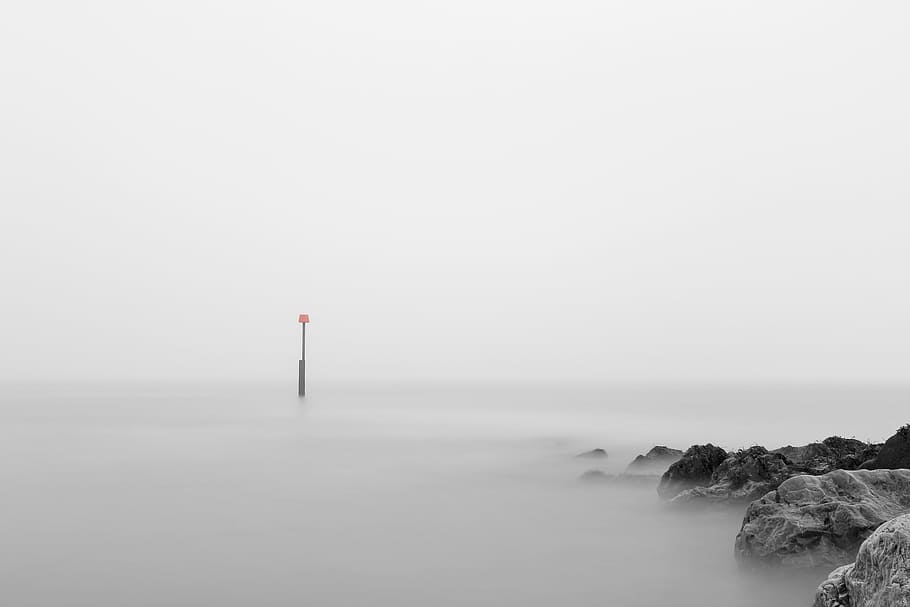 photo of pillar bouy on body of water, foggy and rocky place during daytime HD wallpaper