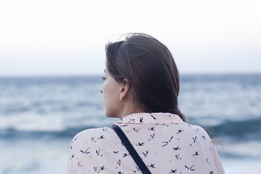 selective focus photography of woman wearing collared shirt in front of body of water during daytime HD wallpaper