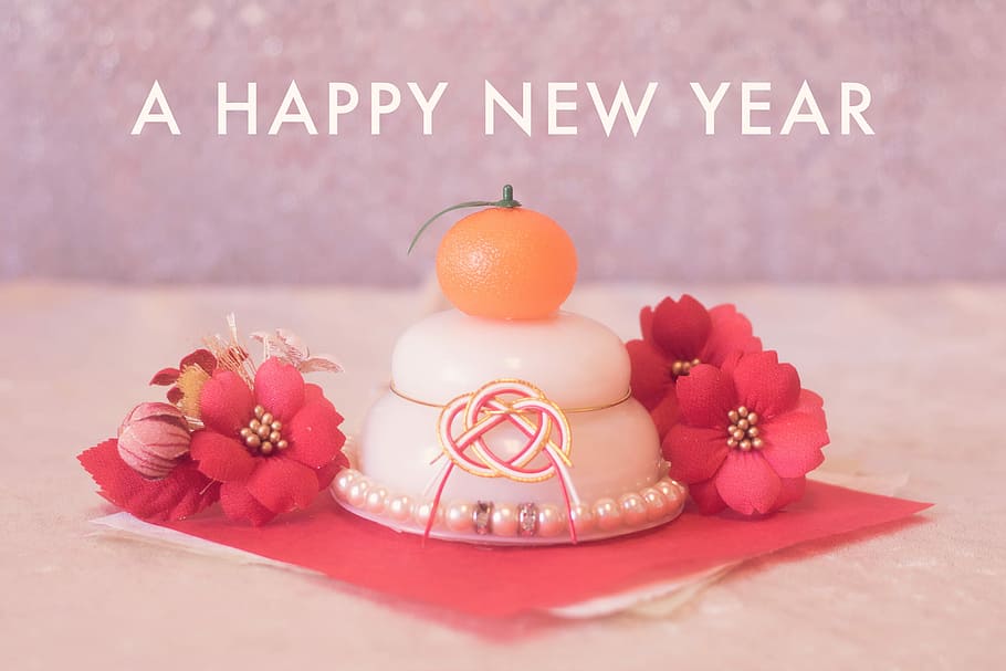 close up photo of white, red, and orange home decors with A Happy New Year text HD wallpaper