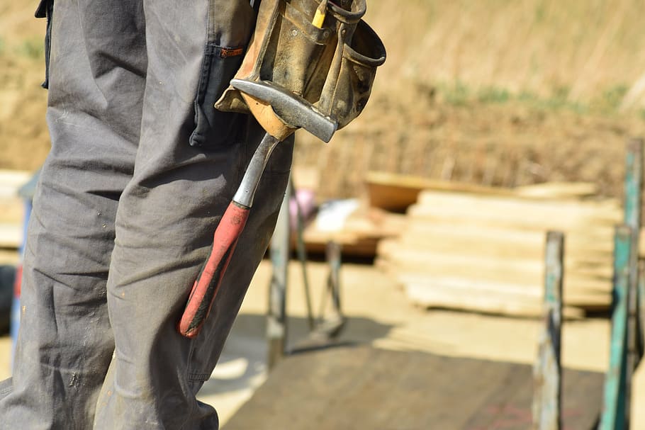 selective focus photography of man holding tool, construction workers HD wallpaper