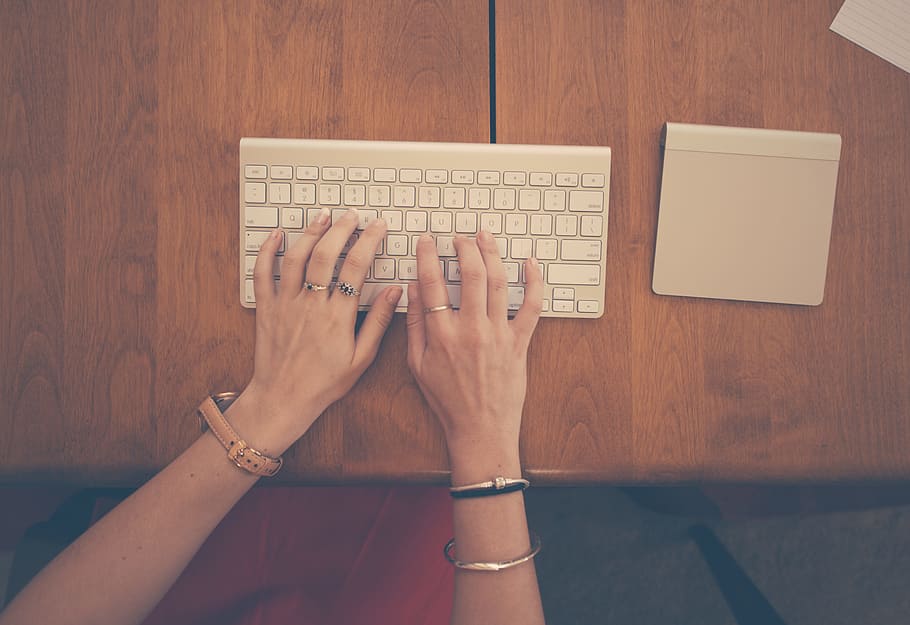 person typing on white computer keyboard, female, hands, trackpad HD wallpaper