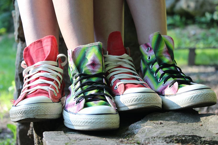 person wearing two pairs of red and green mid-rise shoes during daytime HD wallpaper