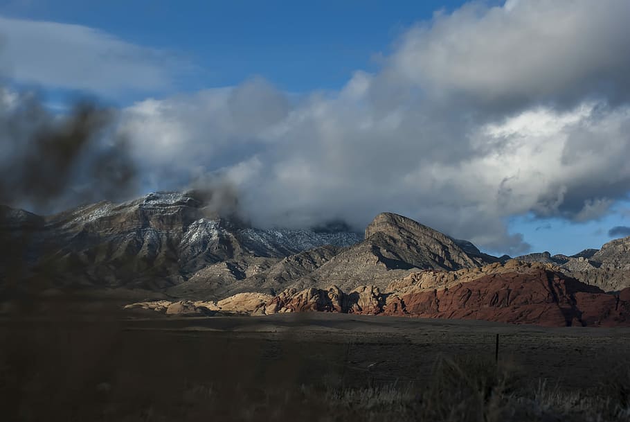 landscape photography of grey mountains under white clouds, mountains under cloudy blue sky during daytime HD wallpaper