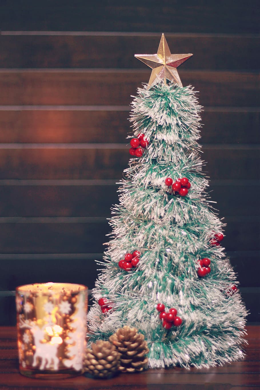 selective focus photography of silver and red decorative chrismas tree with star above and two pine fruits HD wallpaper